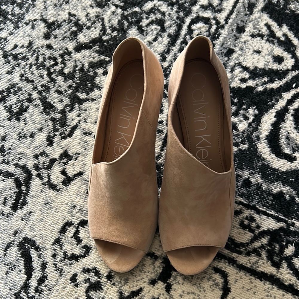 Nude color suede heels.